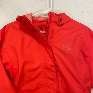 Salmon colored, lightly worn Helly Hansen wind/rain coat/shell.